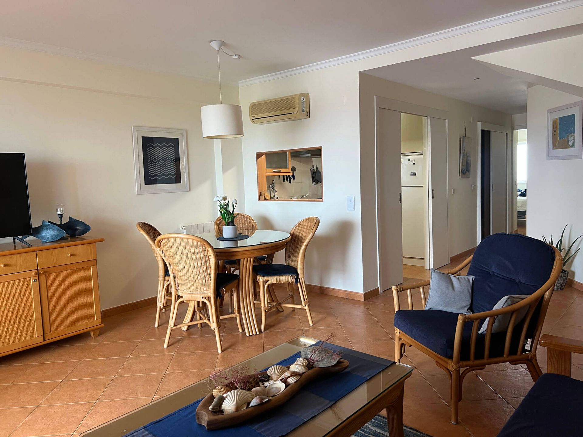 Ein Wohnzimmer mit Tisch und Stühlen und einem Fernseher, Apartment Cabanas