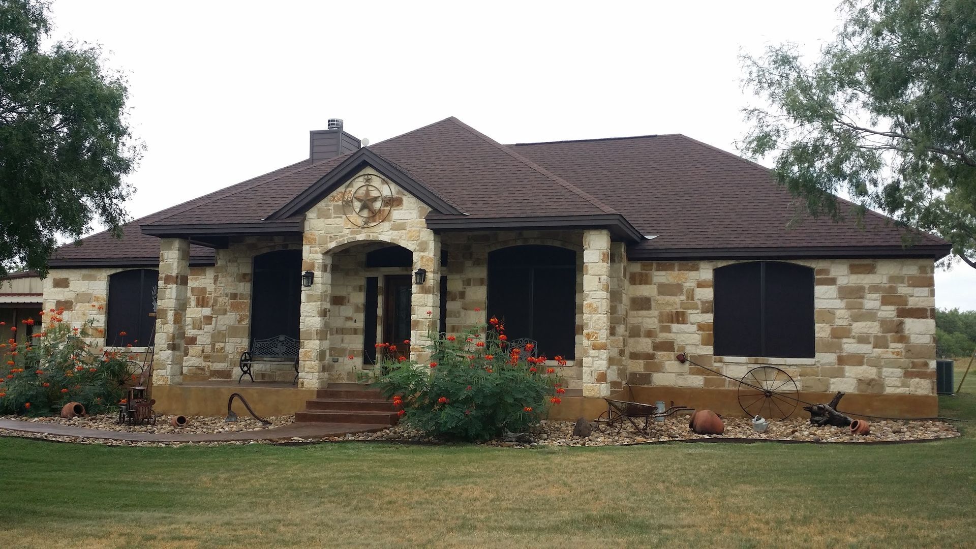 A large brick house with a brown roof and black windows