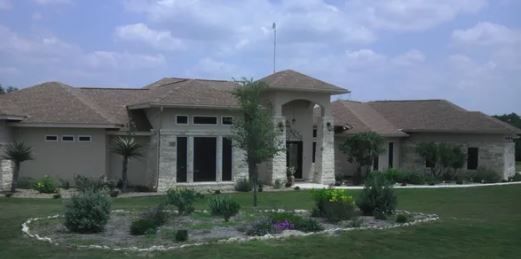 A large house with a large lawn in front of it
