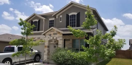 A large house with a truck parked in front of it.