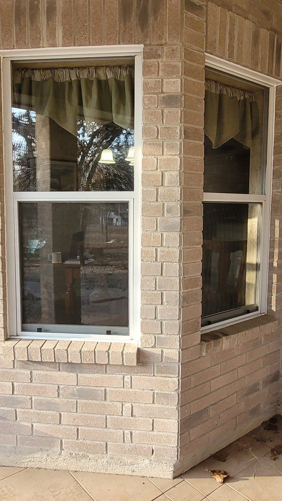 A brick building with a window on the side of it.