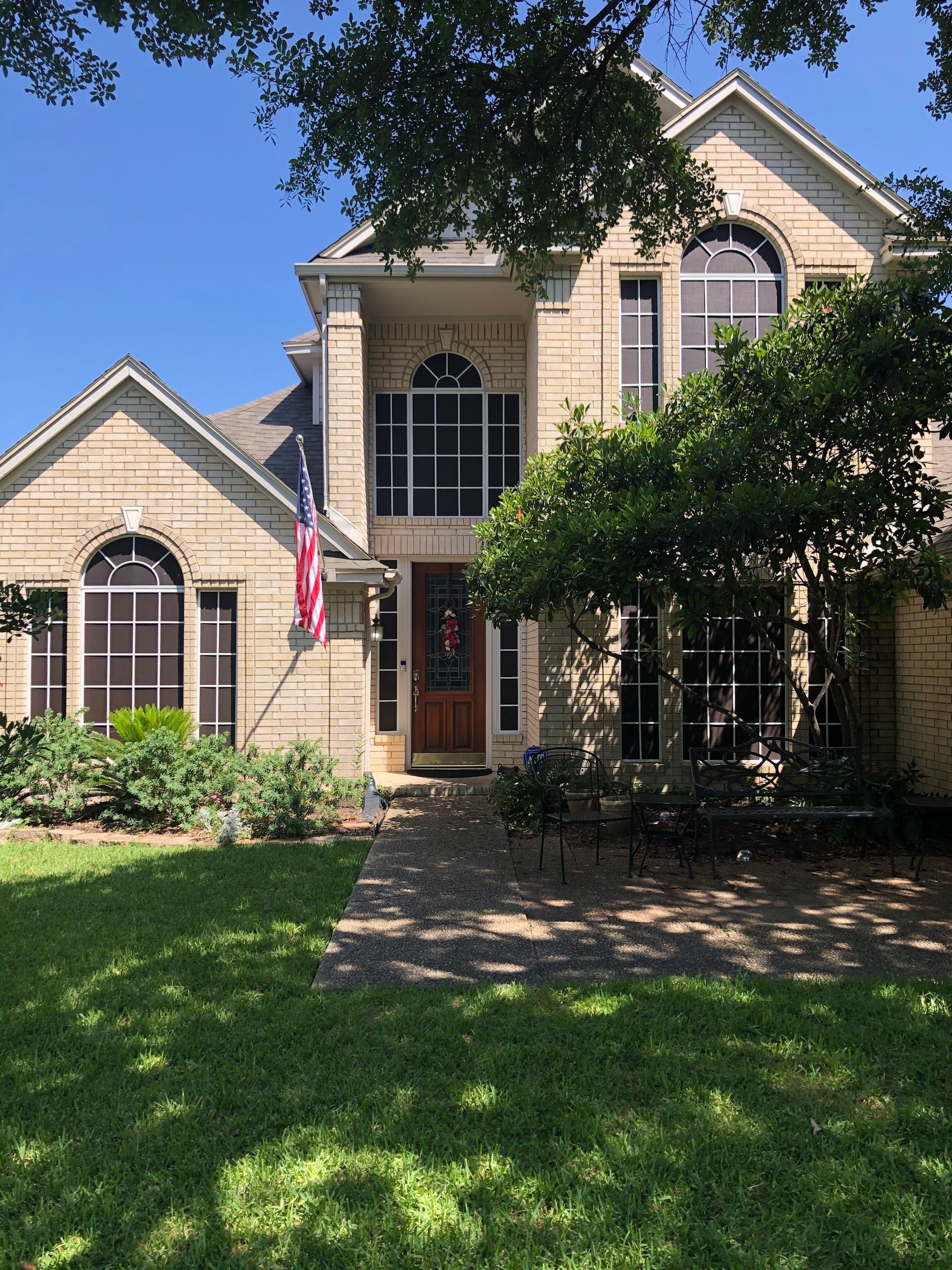 A large house with a lot of windows and trees in front of it.