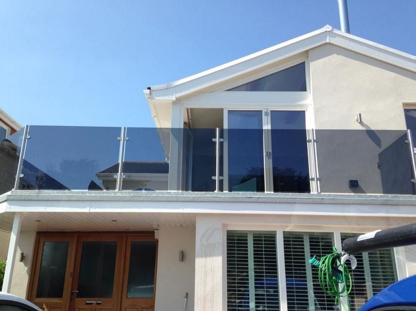 A modern glass handrail divider on a bright day