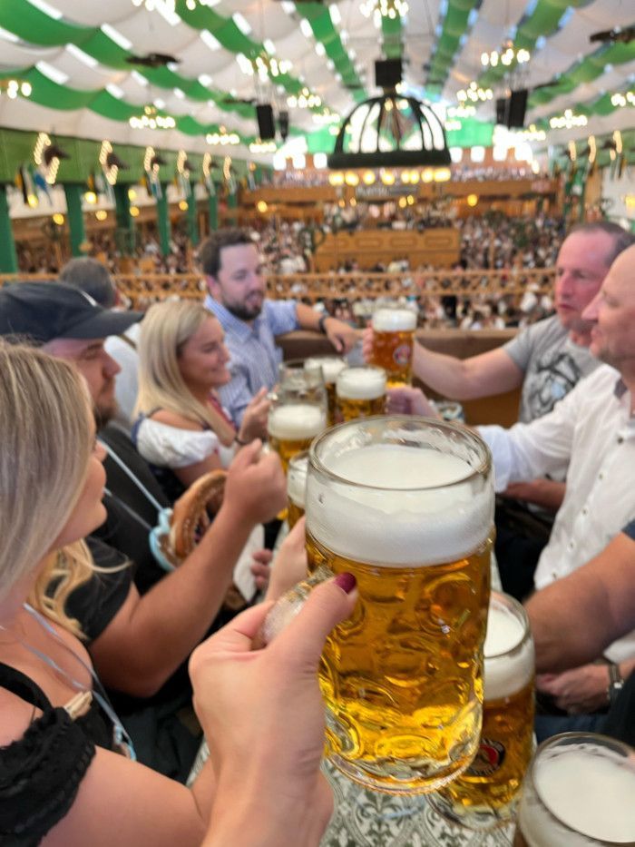 Tour group enjoying Oktoberfest inside the Paulaner beer tent in Munich
