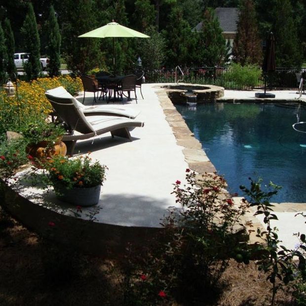 Pool Landscape Construction — Pool With Table and Chairs in Daphne, AL