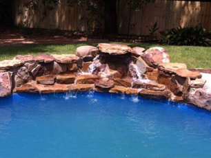 Spa Builders — Pool With Natural Stone Waterfalls in Daphne, AL