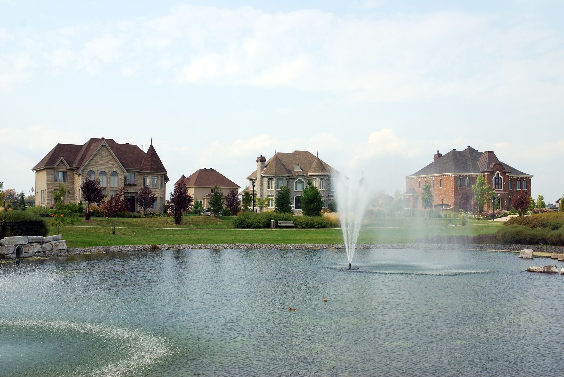 a row of houses on a sunny day with trees in the background