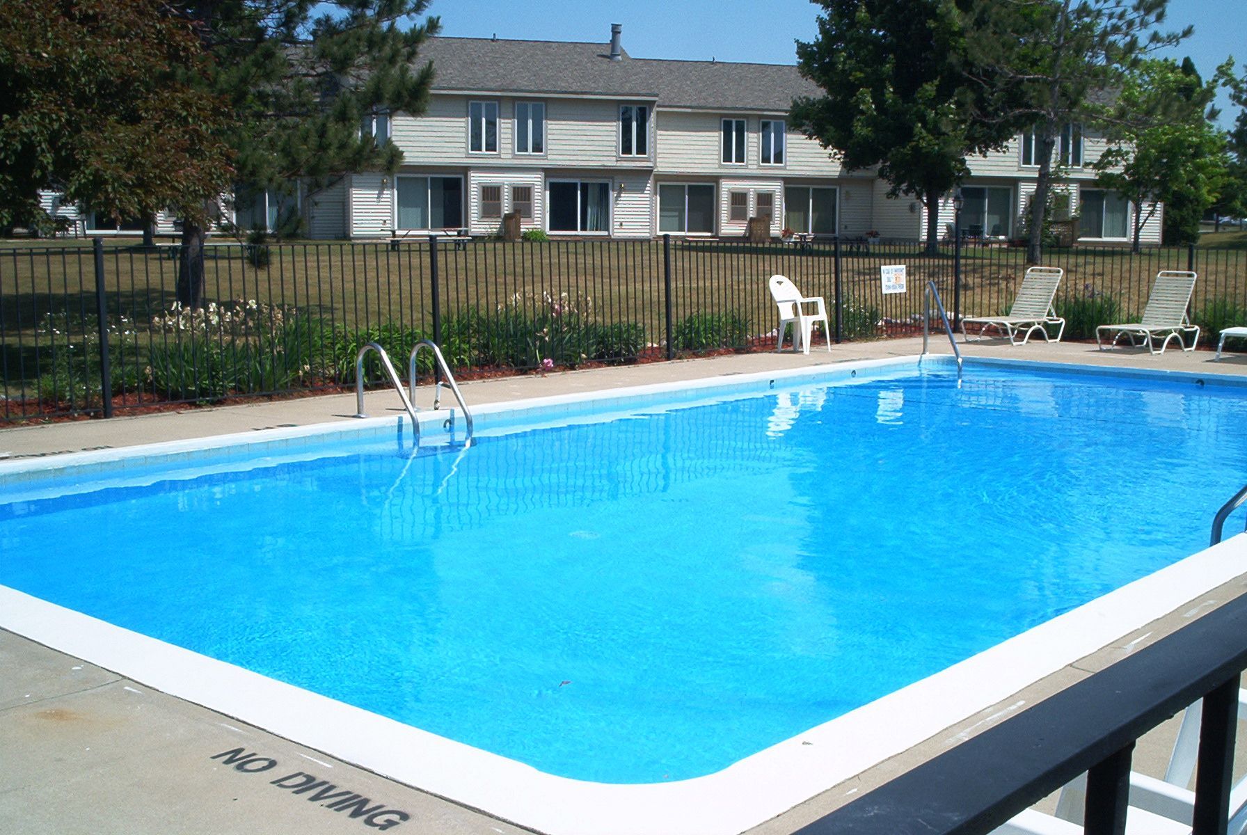 a man is talking on a cell phone while using a laptop computer .