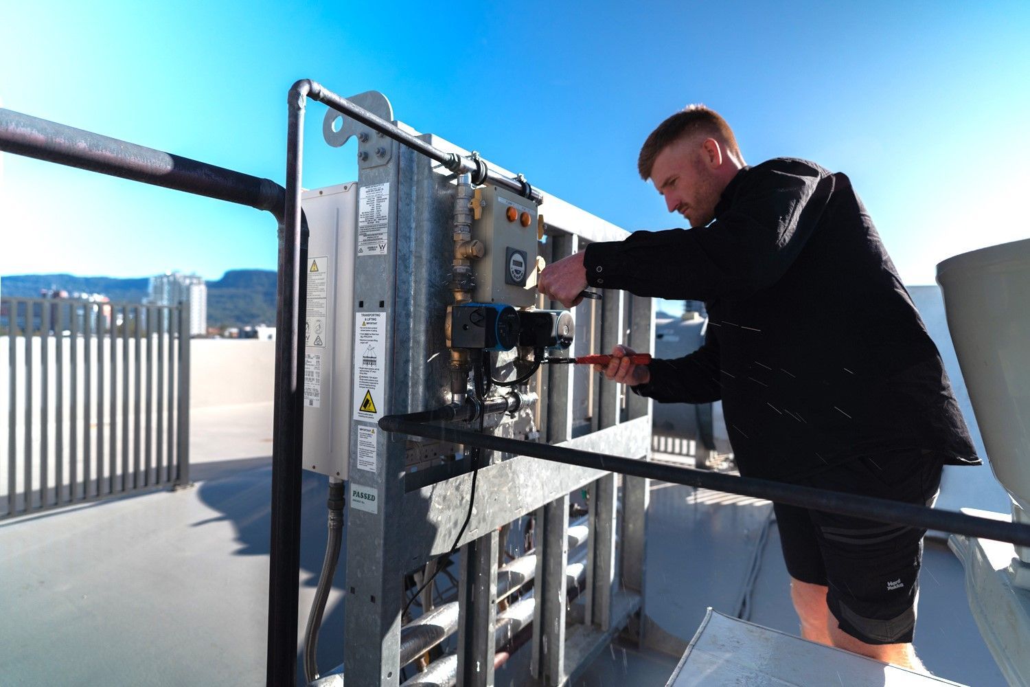 Plumber Fixing Water Tap Using Wrench — Plumber in Wollongong, NSW