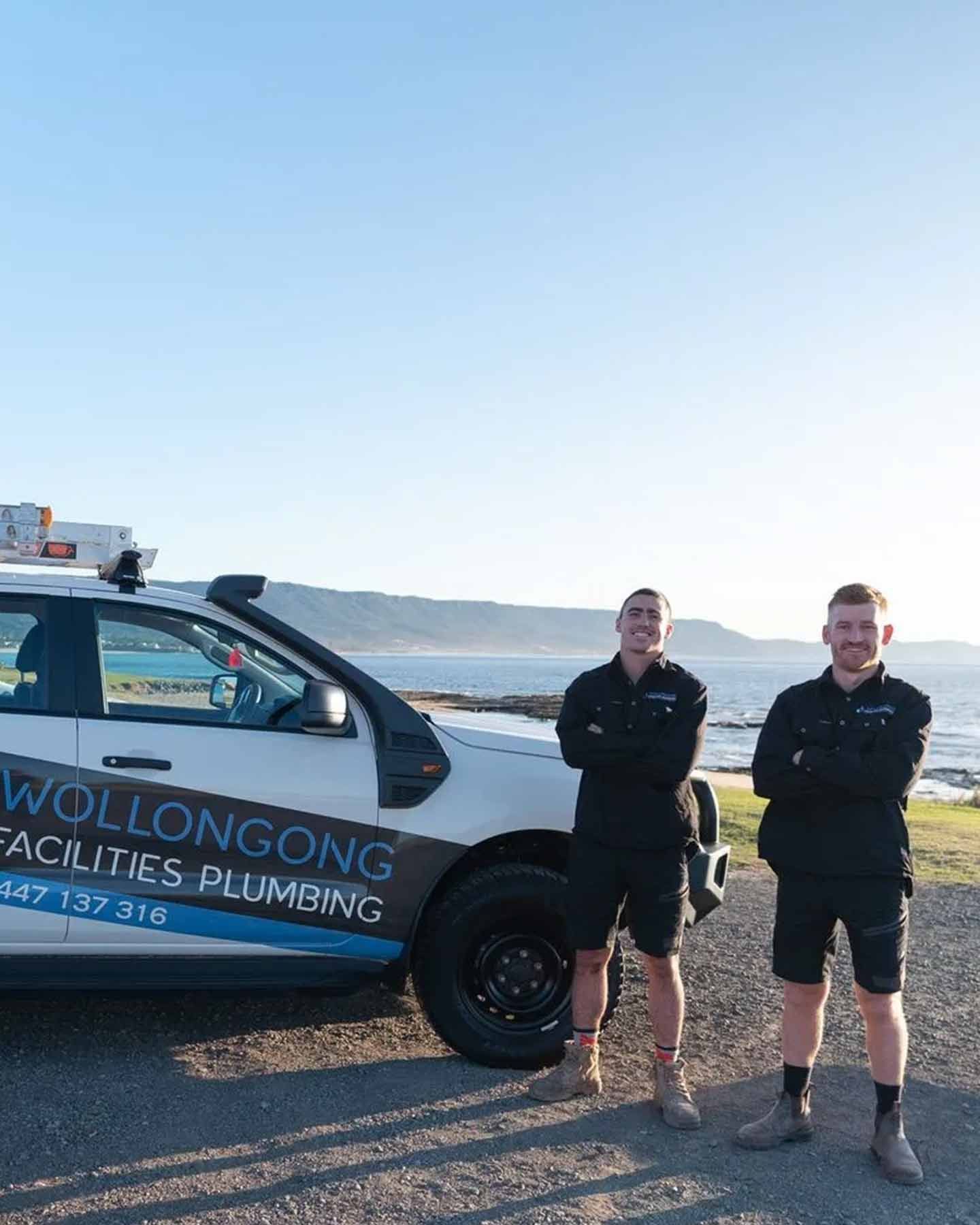Wollongong Plumbers Standing By Car — Plumber in Wollongong, NSW