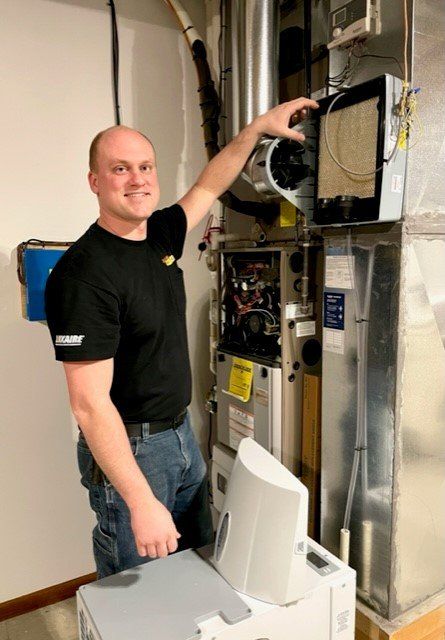 Man Checking The Furnace — Ashtabula, OH — Blank Heating Company Inc
