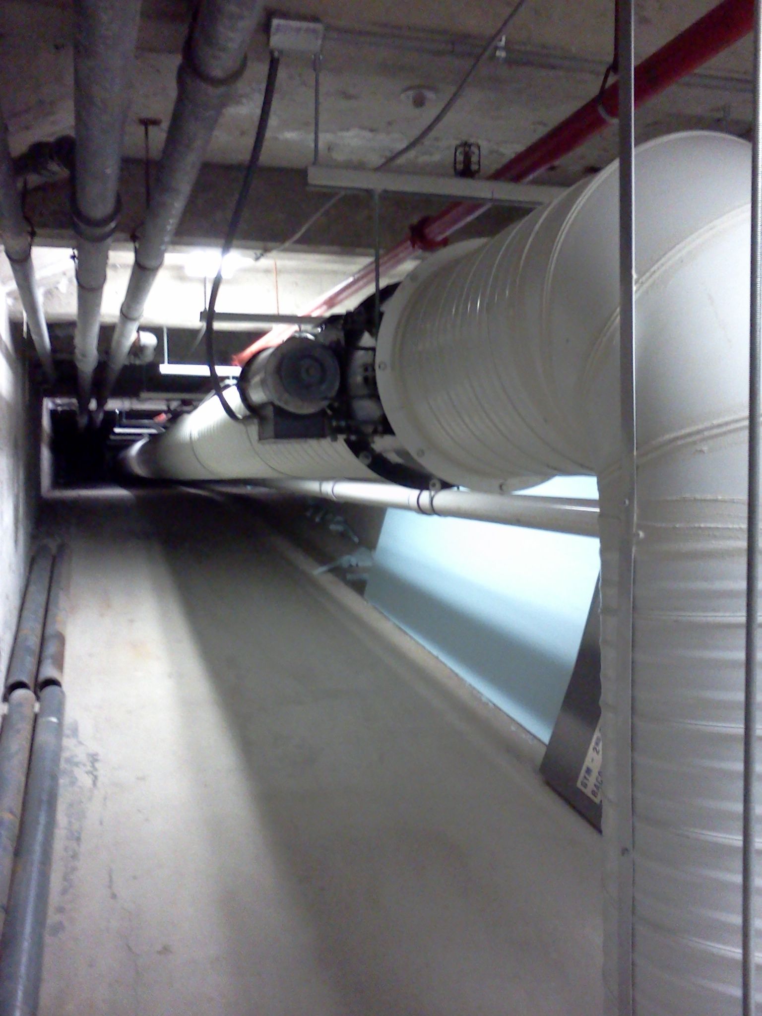 A very long hallway with a lot of pipes