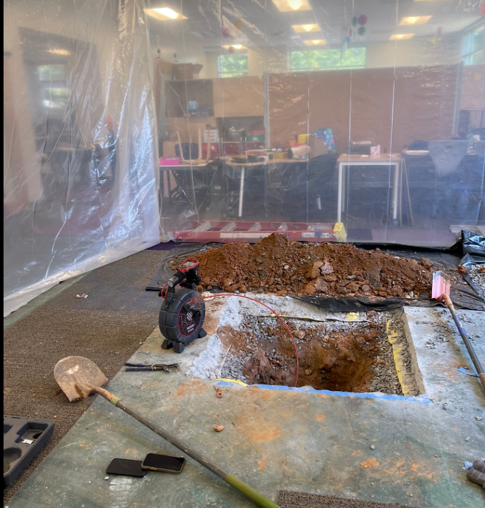 A large pile of dirt is sitting on the floor in a room.