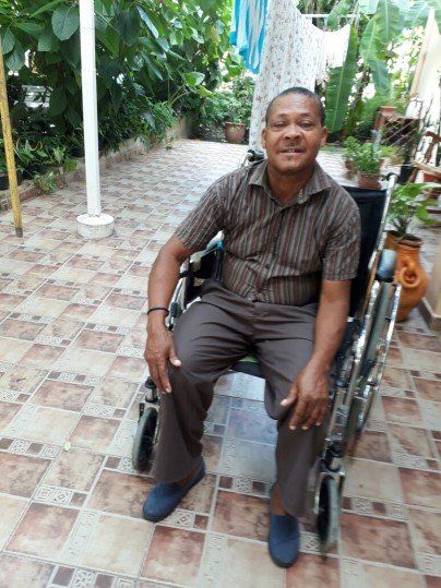 Man received a wheel chair in Santo Domingo, Dominican Republic.