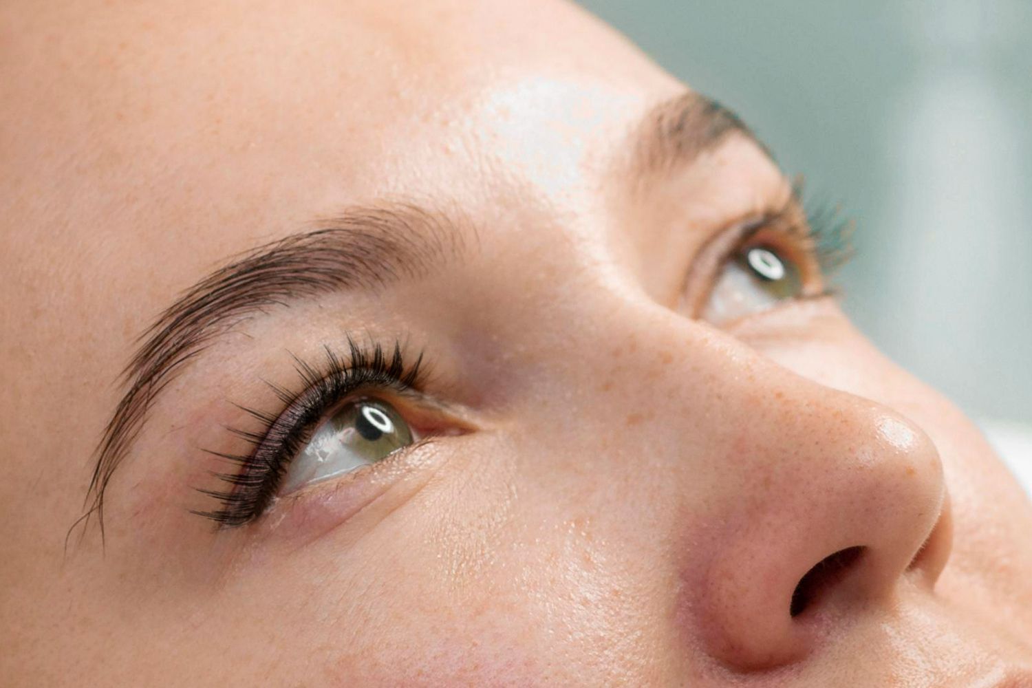 A close up of a woman 's face with her eyes closed.
