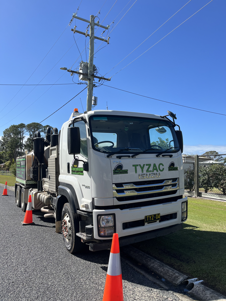 White Tyzac Truck Parked Near a Power Pole With Orange Traffic Cones on a Sunny Day — Tyzac Group in Beerwah, QLD