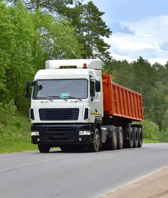 White Dump Truck With Orange Bed on a Paved Road — Tyzac Group in Beerwah, QLD