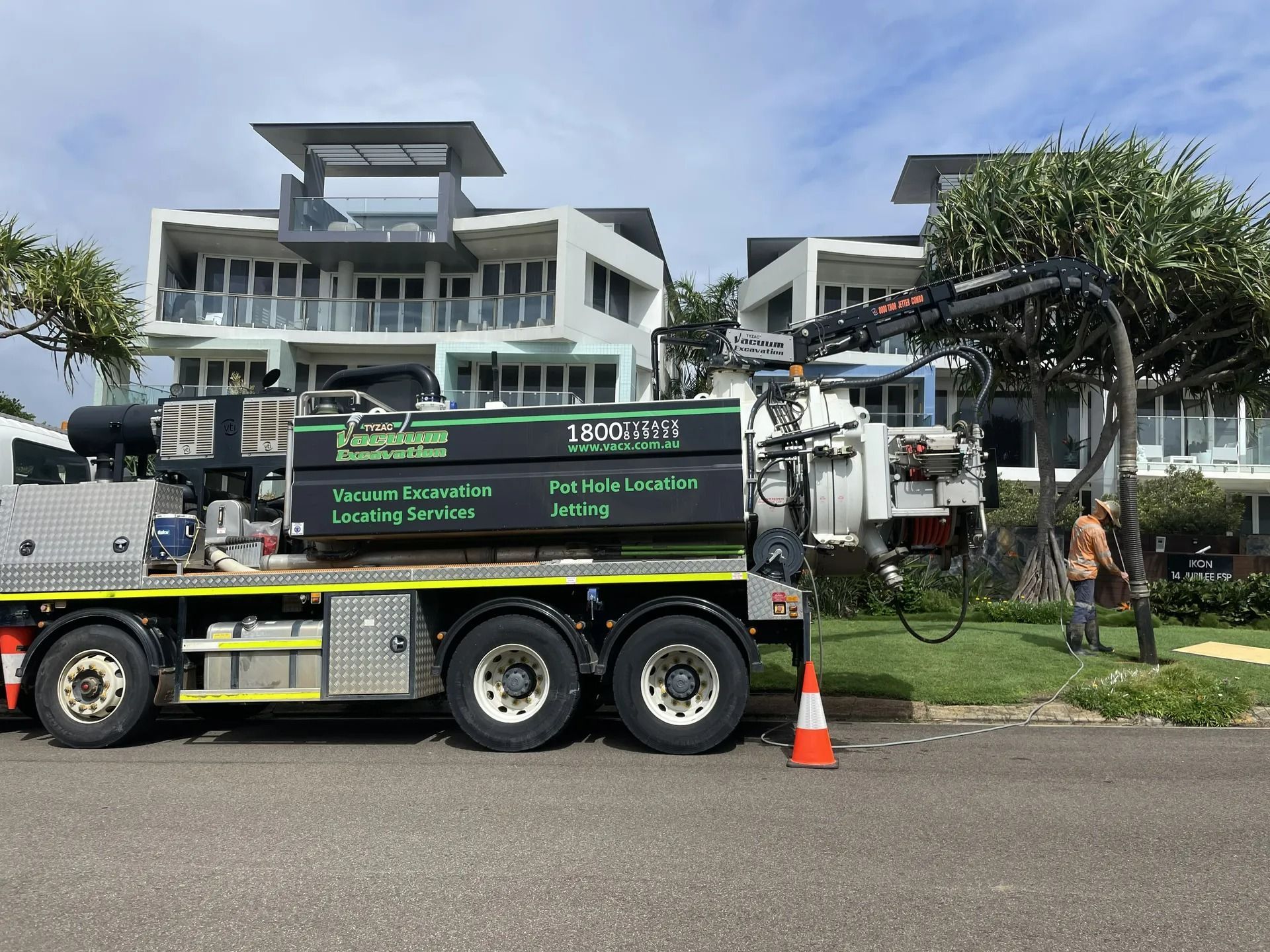 A Drilling Rig on a Truck Parked on a Street Near a Large White Building — Tyzac Group in Beerwah, QLD
