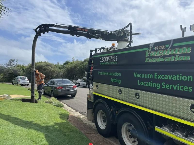 Vacuum Truck Excavating on a Roadside, a Worker Directing the Hose — Tyzac Group in Beerwah, QLD