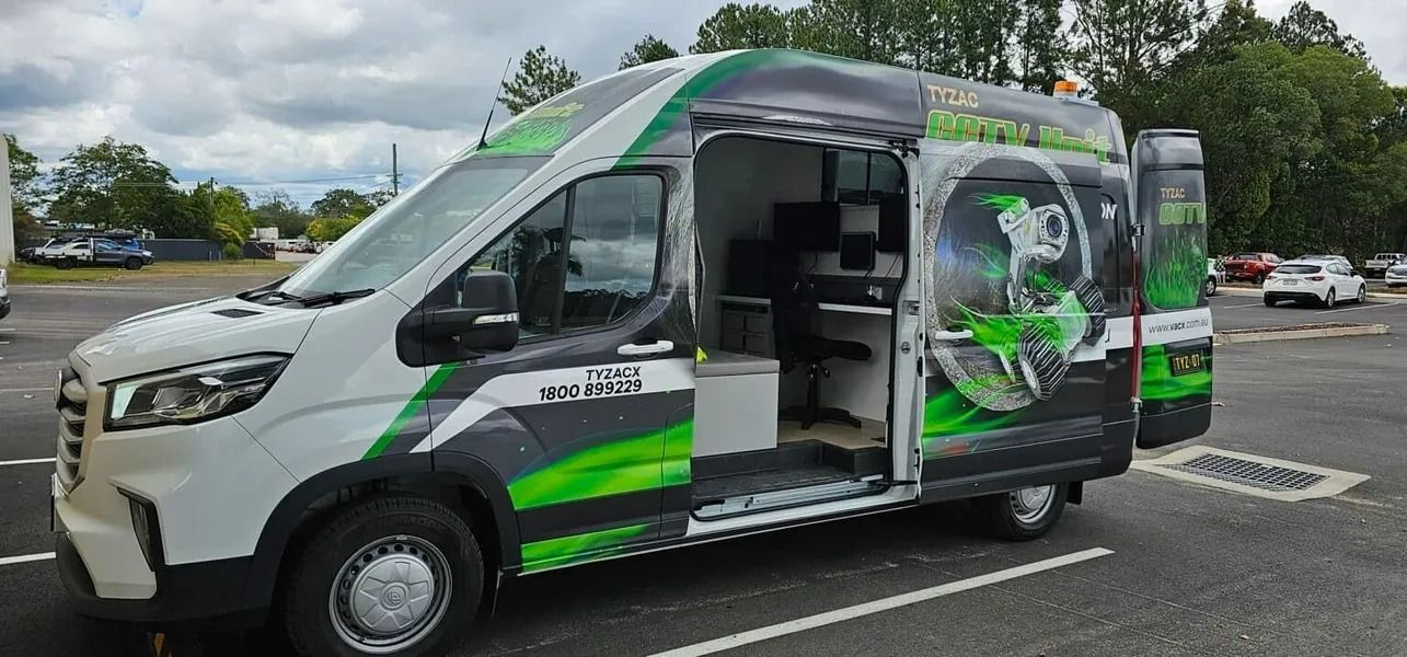 White Van With Green Accents and Open Side Door, Parked in Lot — Tyzac Group in Beerwah, QLD