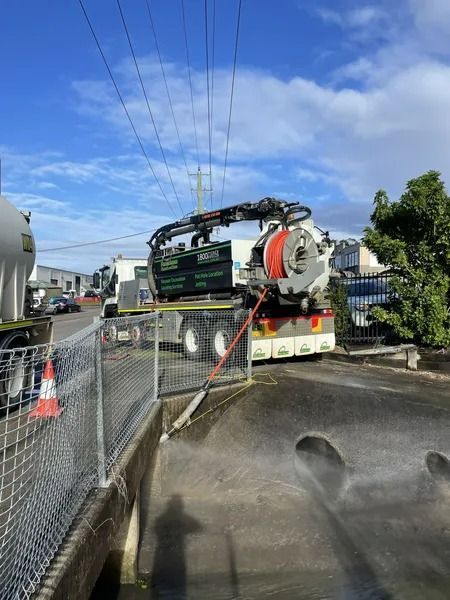 A White Truck With a Large Tank and Hose Positioned Near a Chain-link Fence — Tyzac Group in Beerwah, QLD