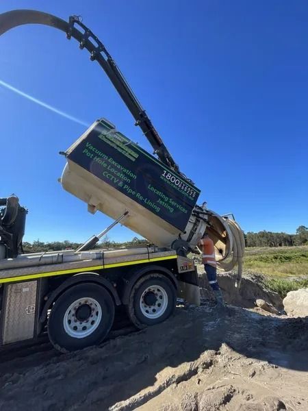 Truck Dumping Contents Into a Hole on a Sunny Day — Tyzac Group in Beerwah, QLD