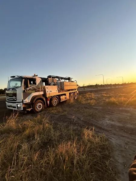 A Large White Utility Truck Parked in a Field at Sunset — Tyzac Group in Beerwah, QLD