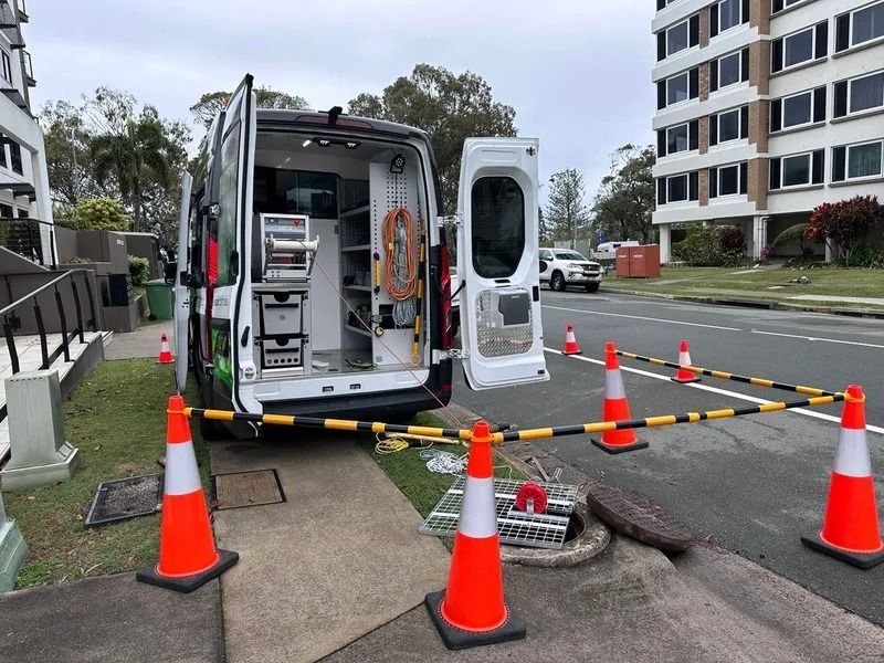 A Service Van Parked on a Street With Its Doors Open — Tyzac Group in Beerwah, QLD