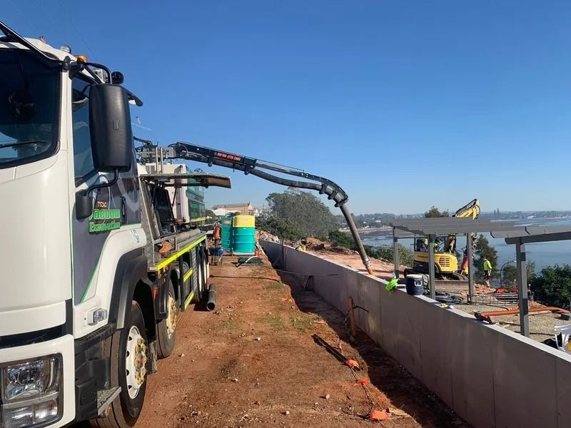 Concrete Pump Truck Pouring Concrete Into a Construction Site Wall — Tyzac Group in Beerwah, QLD