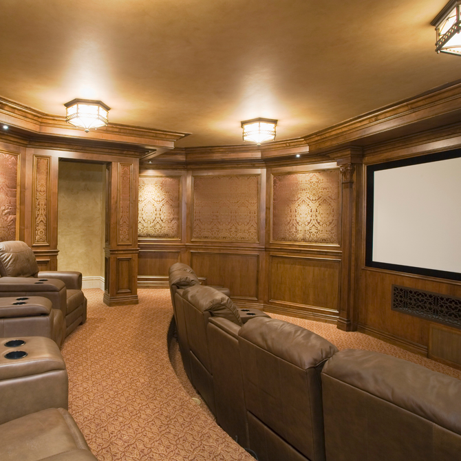 Electrician testing an EV charger circuit breaker with a multimeter. White wall, black cable.