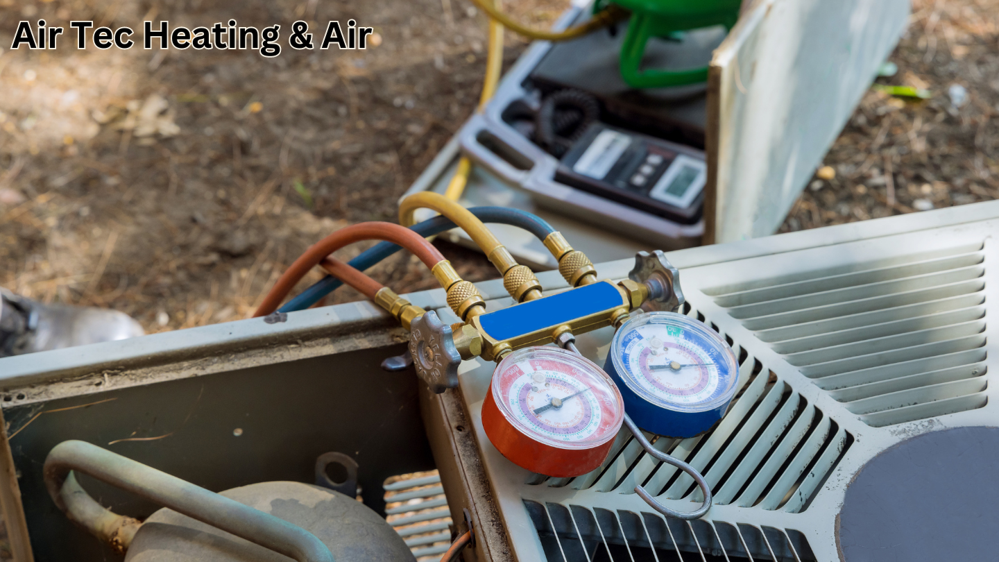 A close up of a refrigerator with two gauges attached to it.