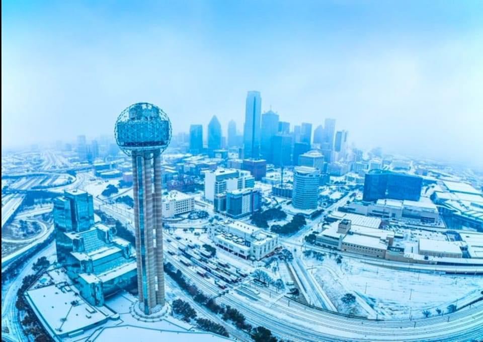 An aerial view of a city covered in snow.