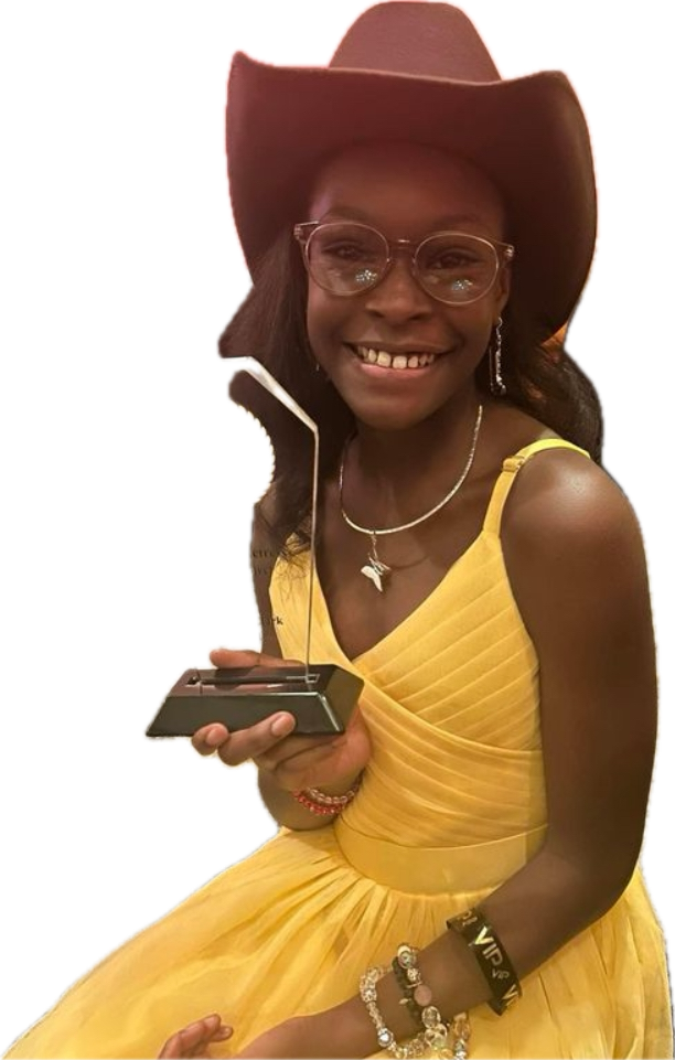 A woman wearing a cowboy hat and glasses is holding a trophy.