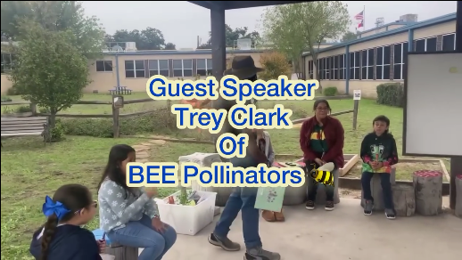 A group of children are sitting on a bench in front of a white board with the words guest speaker trey clark