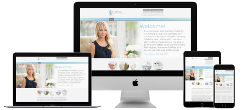 A woman is sitting on a couch in front of a computer , tablet , and phone.