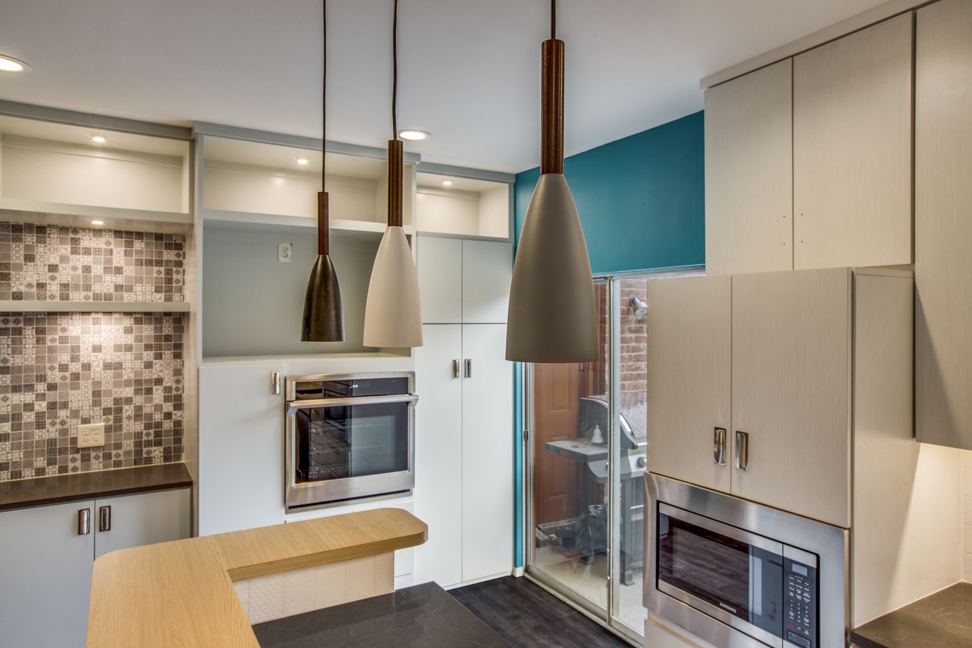 A kitchen with stainless steel appliances and white cabinets