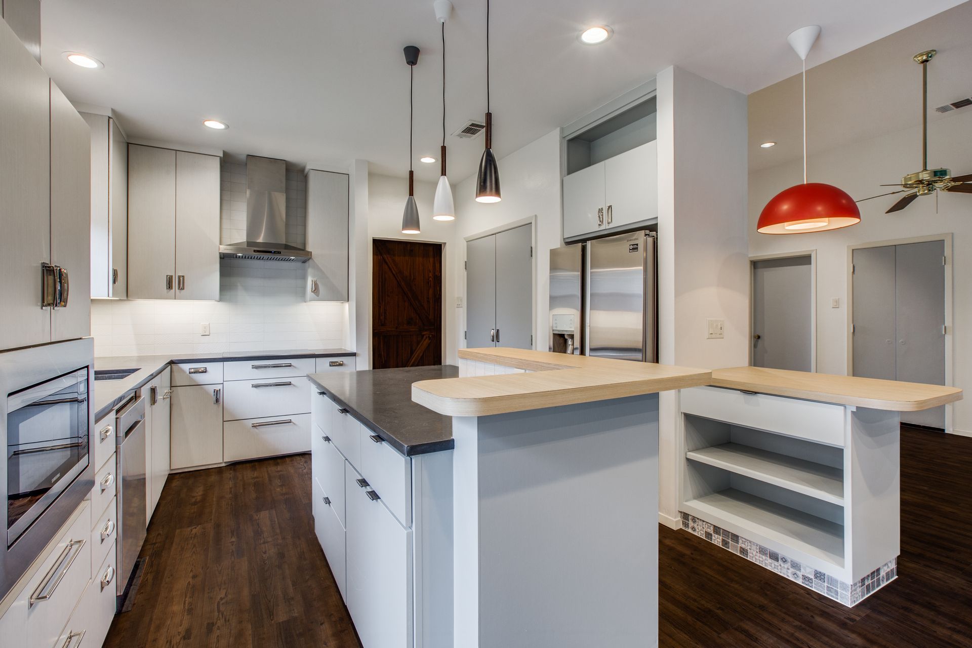 A kitchen with white cabinets and stainless steel appliances