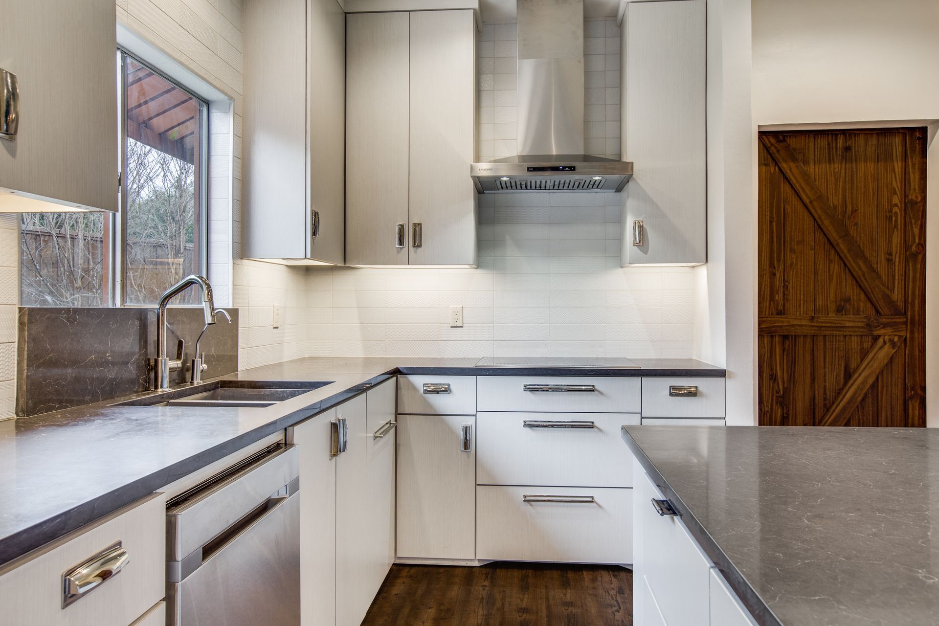 A kitchen with white cabinets and stainless steel appliances