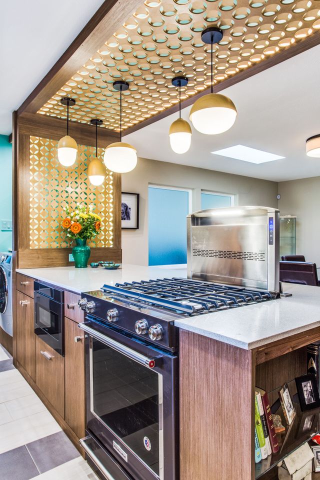 A kitchen with a stove , oven , and microwave.