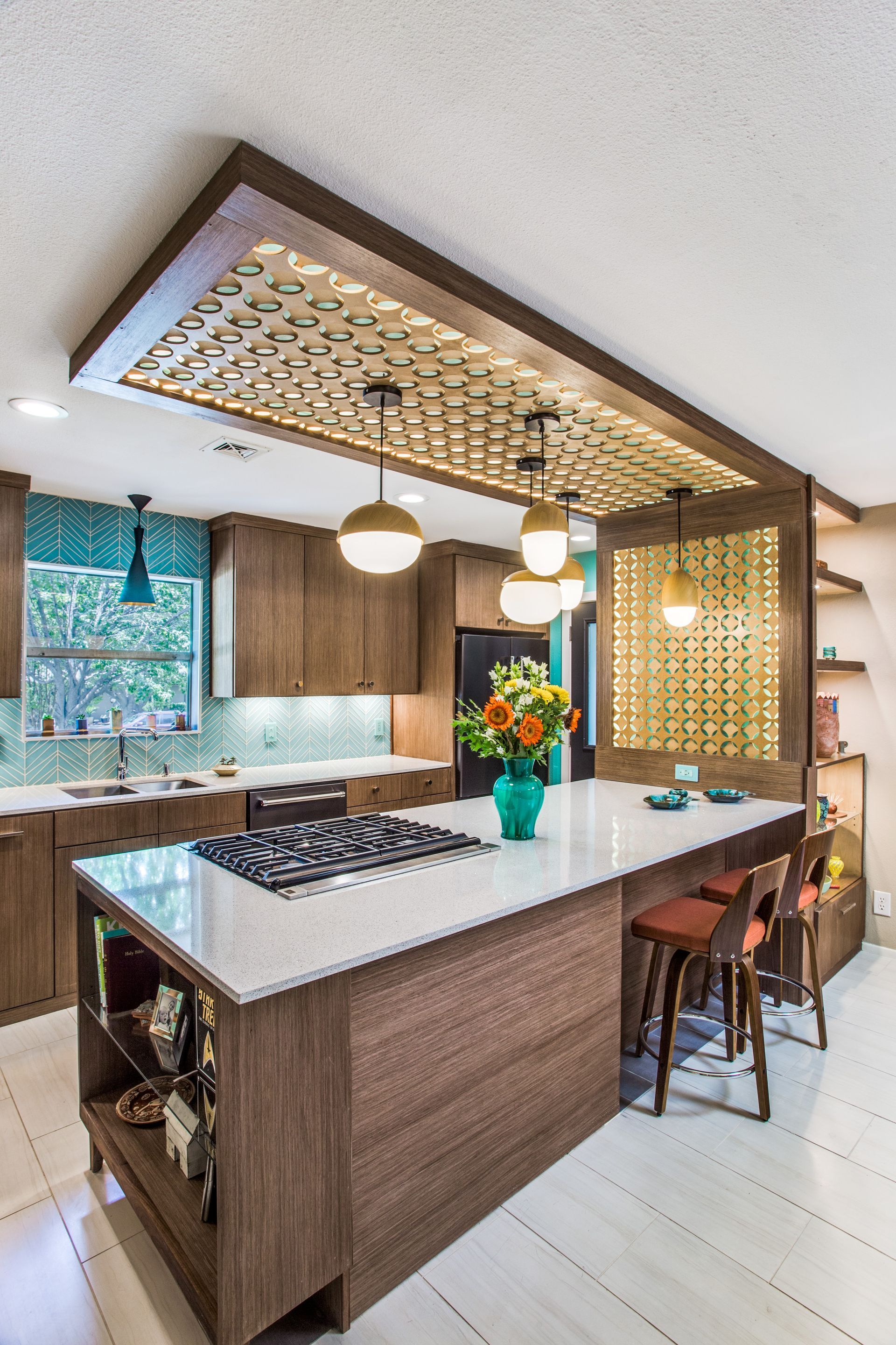 A kitchen with a large island and a stove top oven.