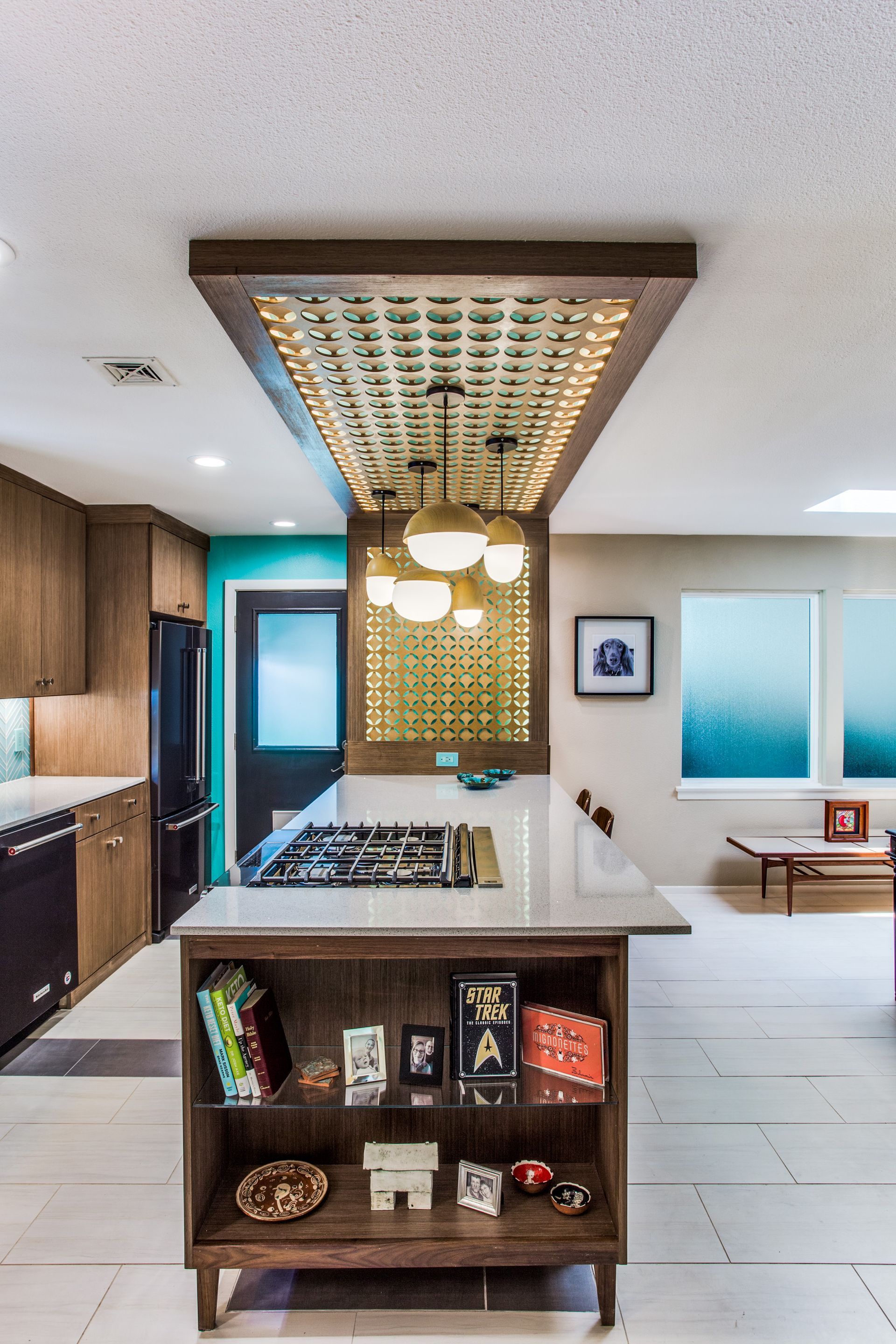 A kitchen with a large island and a sink.