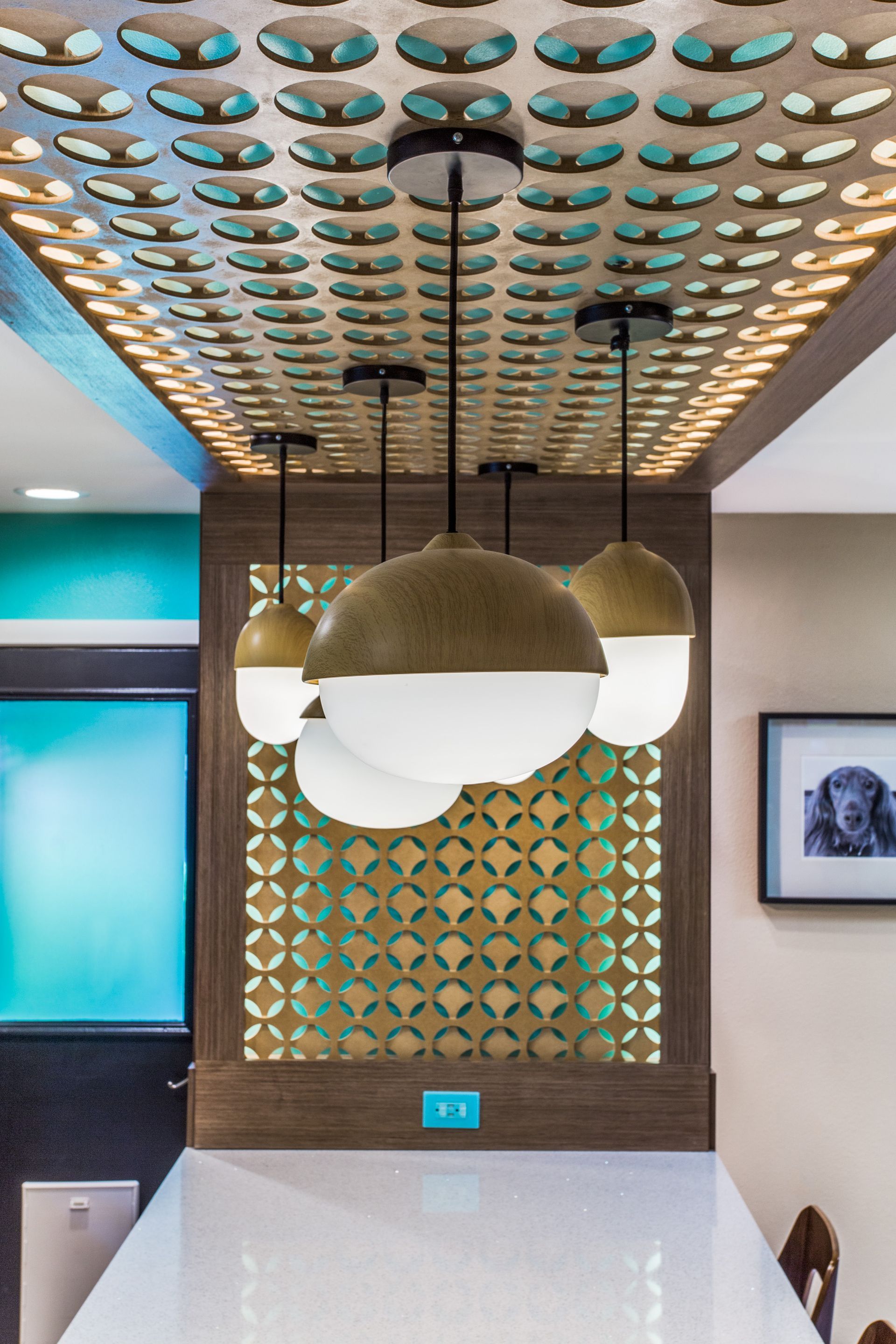 A room with a ceiling that has a lot of holes in it and a picture of a dog on the wall.