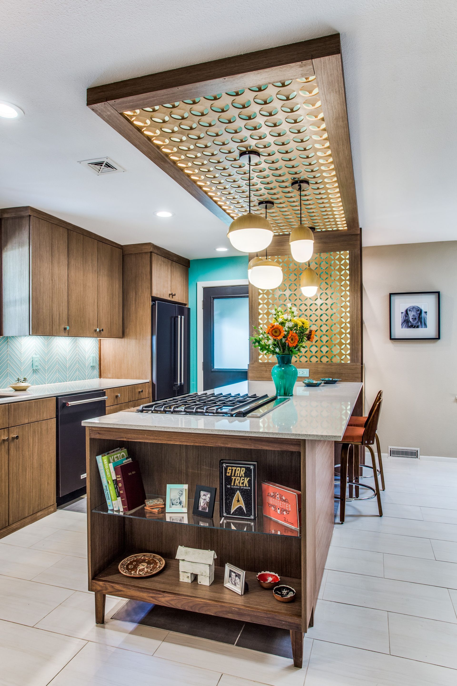 A kitchen with a large island and a stove top oven.