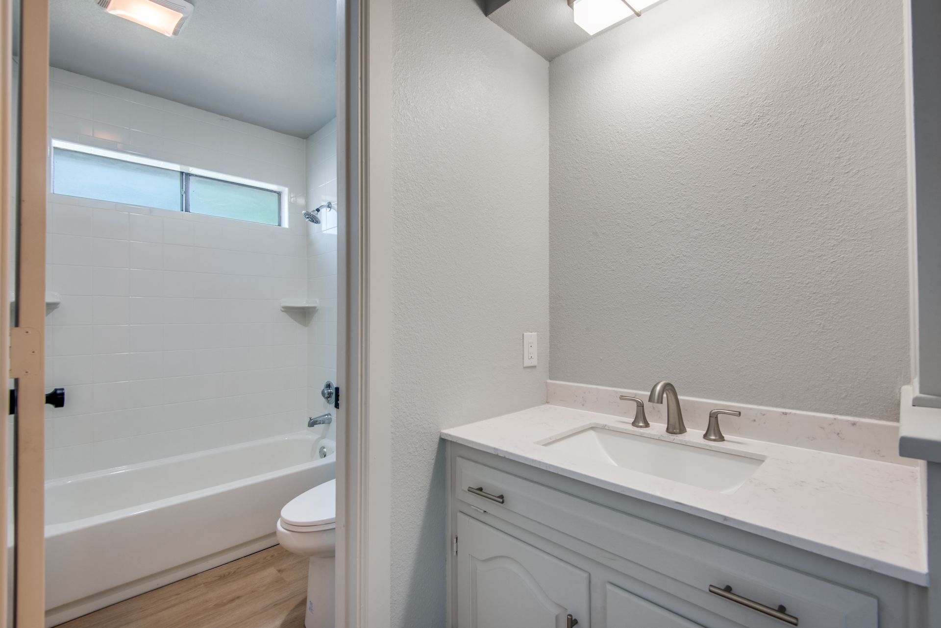 A bathroom remodel with a sink , toilet and bathtub.