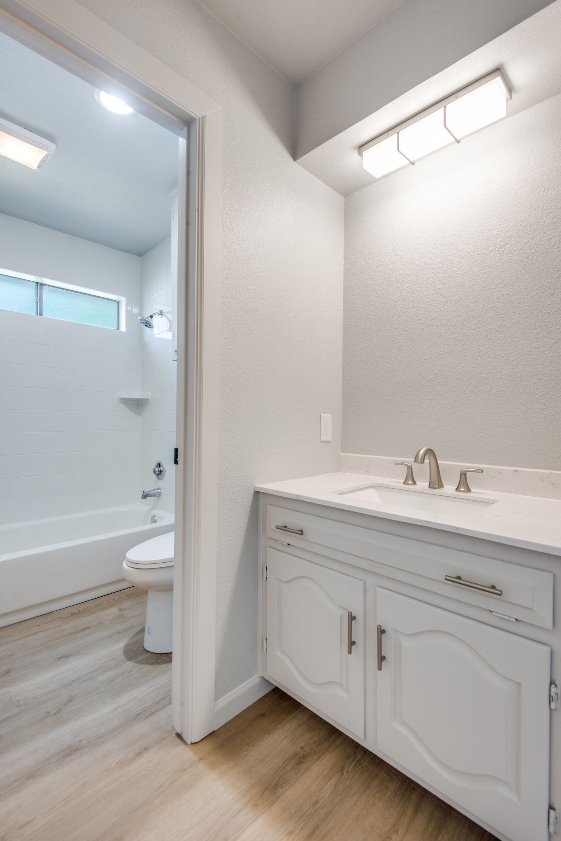 A bathroom with a sink , toilet and bathtub.