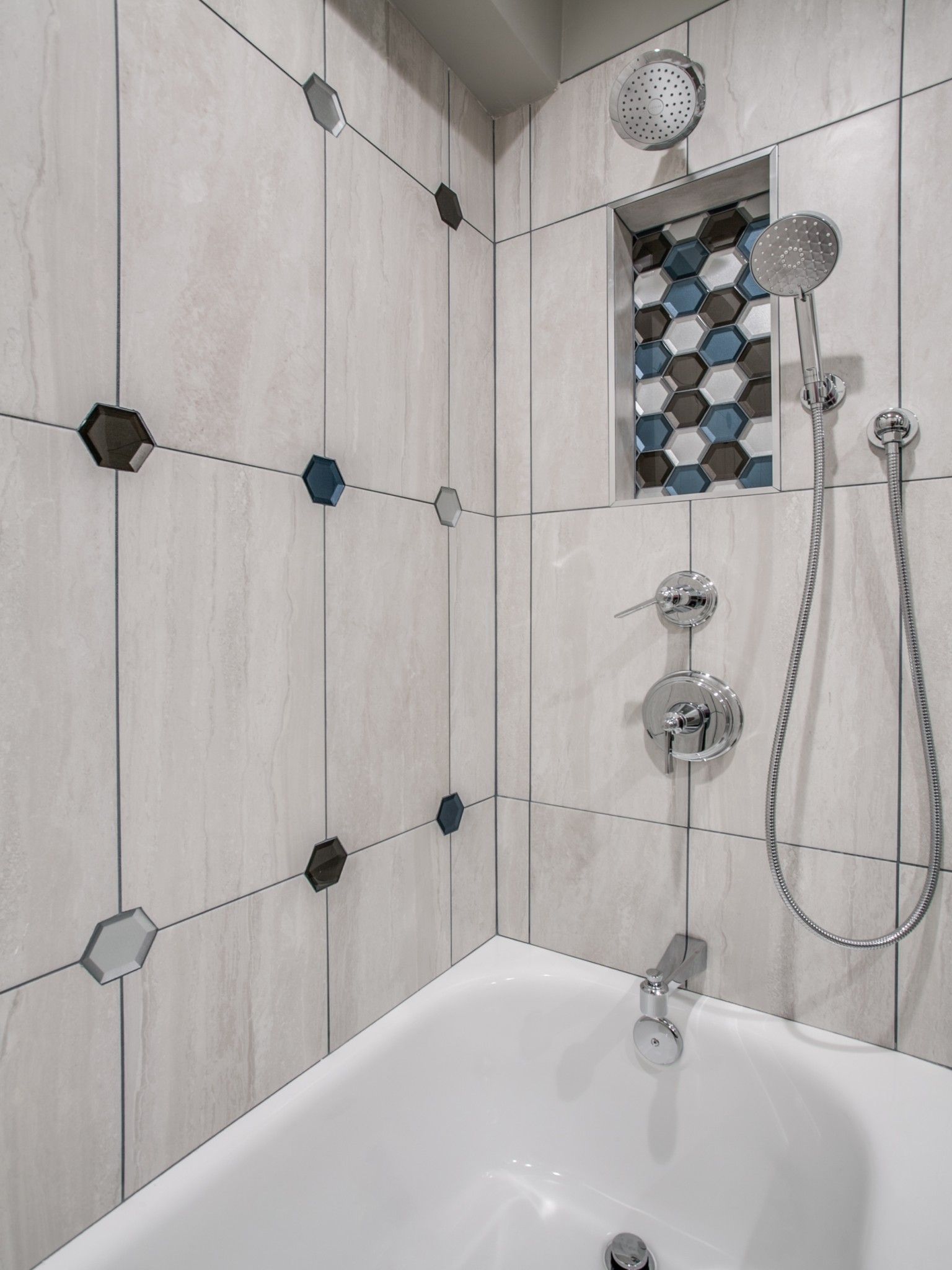 A bathroom with a bathtub and a shower head.