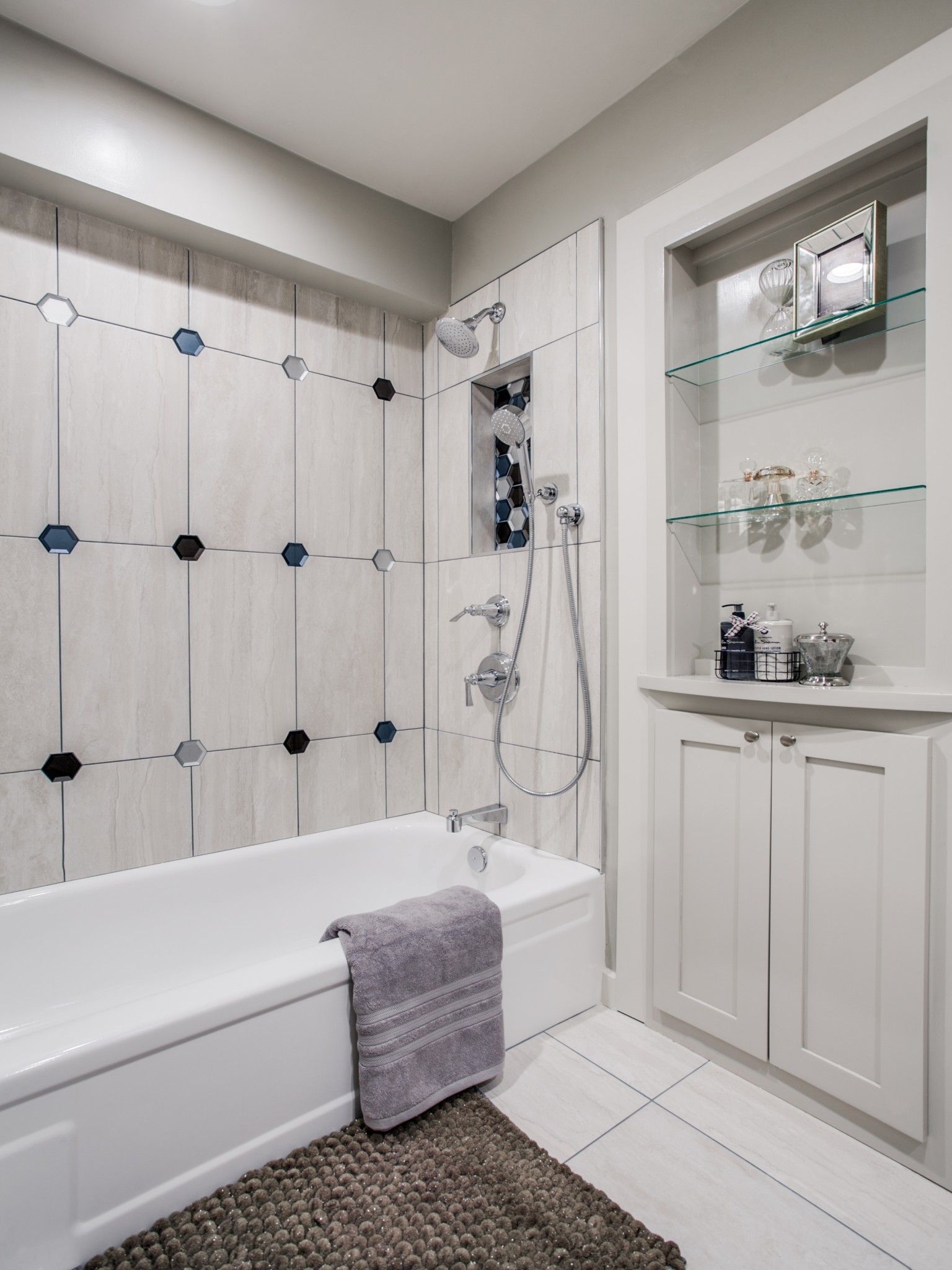 A bathroom with a bathtub , sink , and shower.