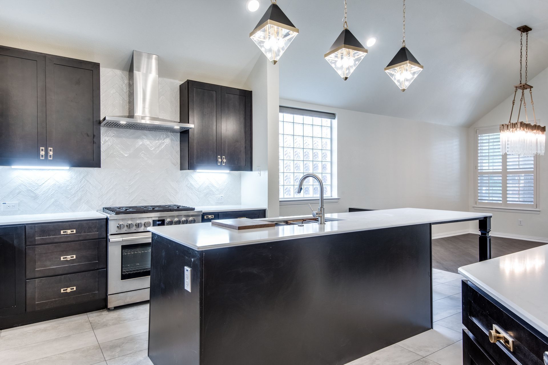 A kitchen with stainless steel appliances and black cabinets