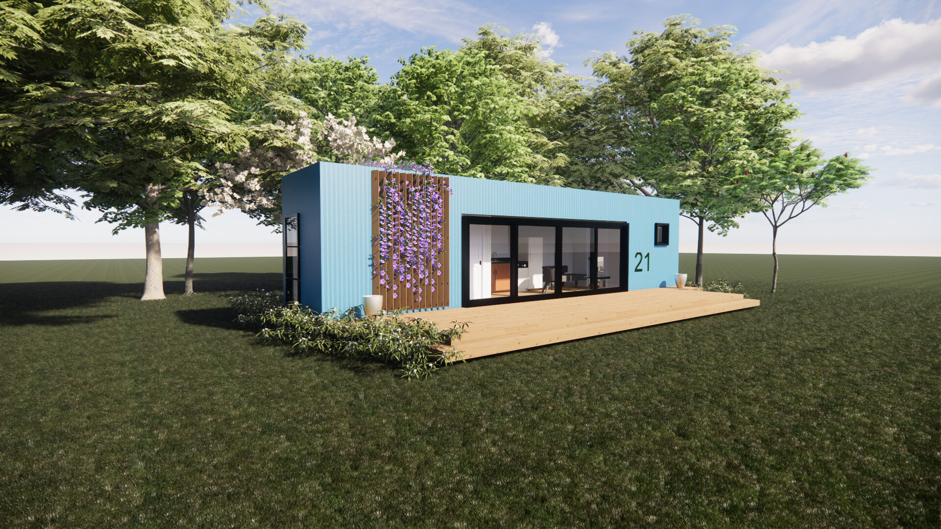A blue shipping container house is sitting on top of a lush green field surrounded by trees.
