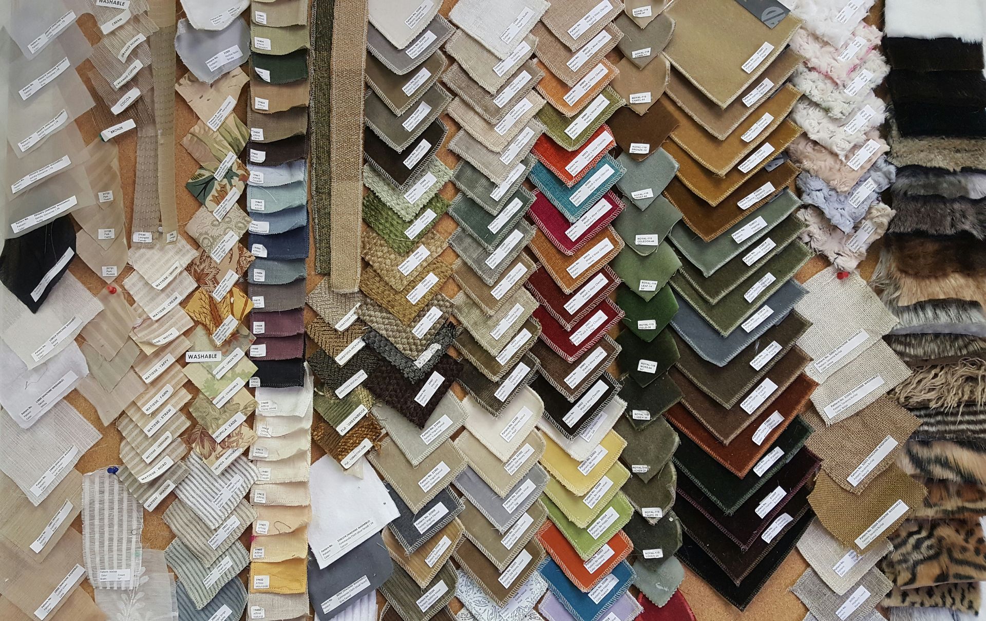 A bunch of different colored fabrics are stacked on top of each other